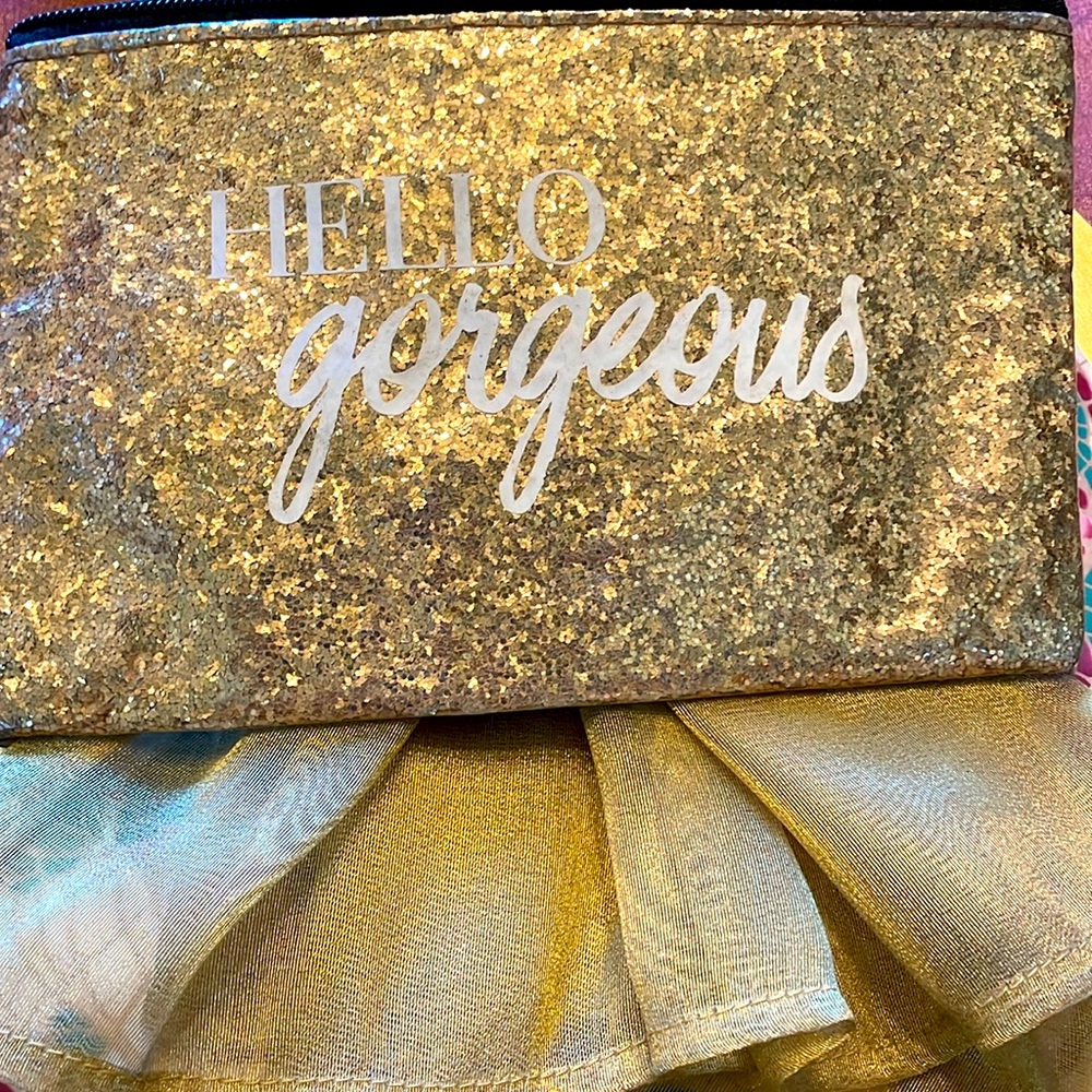 Gold metallic top zip cosmetic or inside purse bag. GUC “Hello Gorgeous”